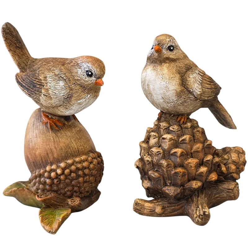 2 Vogelfiguren auf Eichel und Tannenzapfen aus Kunststein 11 cm